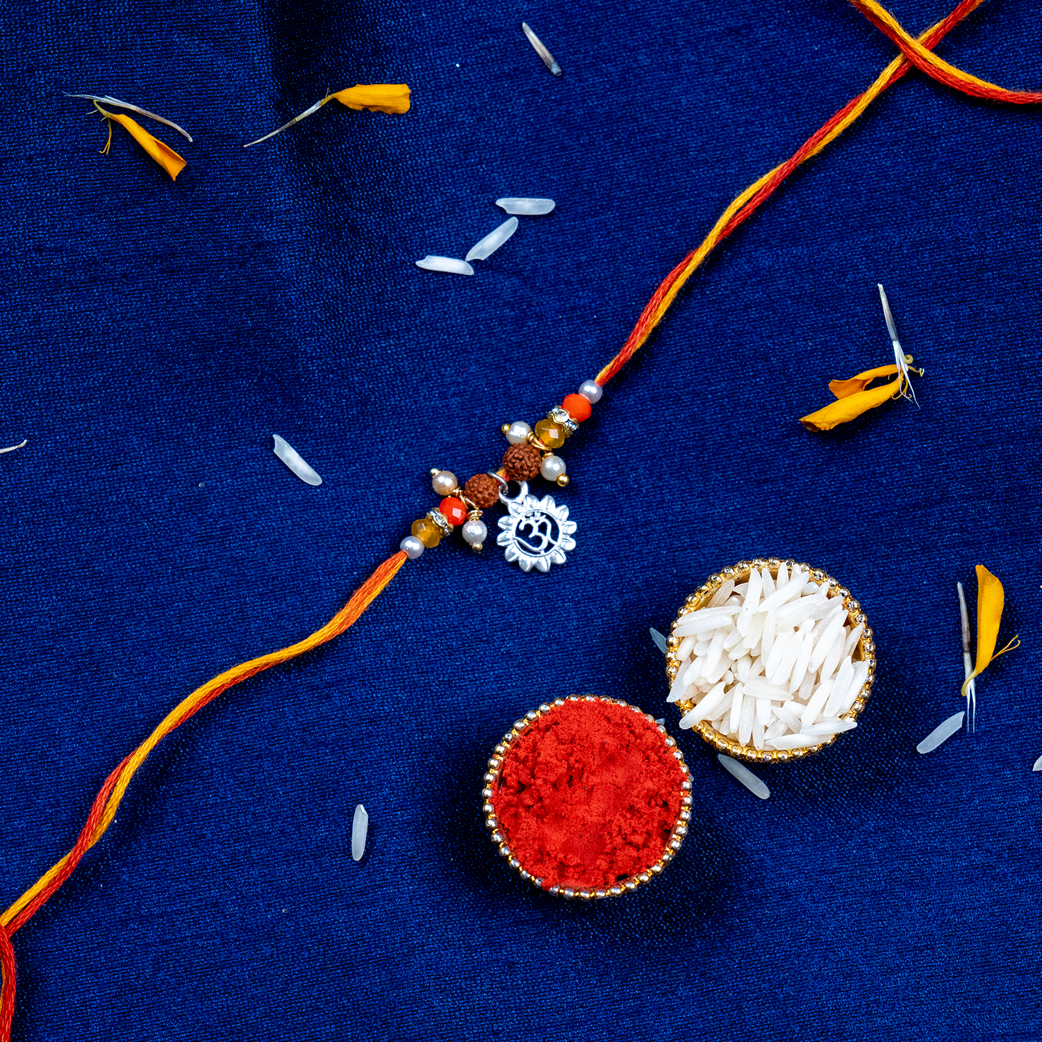Sacred Silver Om Charm Rakhi – Handcrafted Spiritual Mauli Thread for Brother