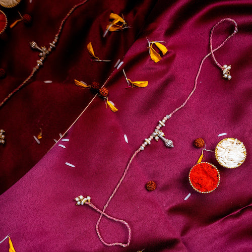 Divine Silver Charm Rakhi – Handcrafted Traditional Silk Thread for Brother