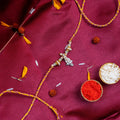 Sacred Silver Ganesha Charm Rakhi – Handcrafted Traditional Mauli Thread for Brother