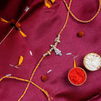 Sacred Silver Ganesha Charm Rakhi – Handcrafted Traditional Mauli Thread for Brother