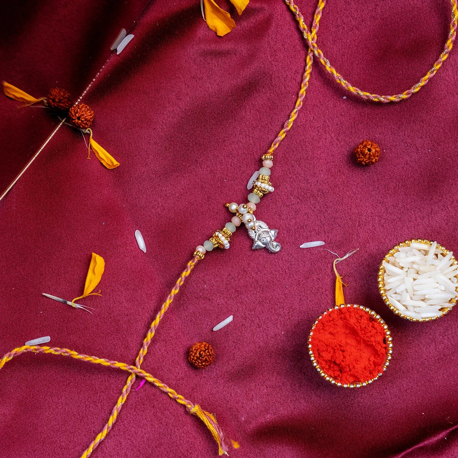 Sacred Silver Ganesha Charm Rakhi – Handcrafted Traditional Mauli Thread for Brother