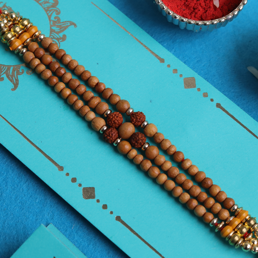 Sacred Bond: Triple-Strand Rudraksha & Sandalwood Designer Rakhi