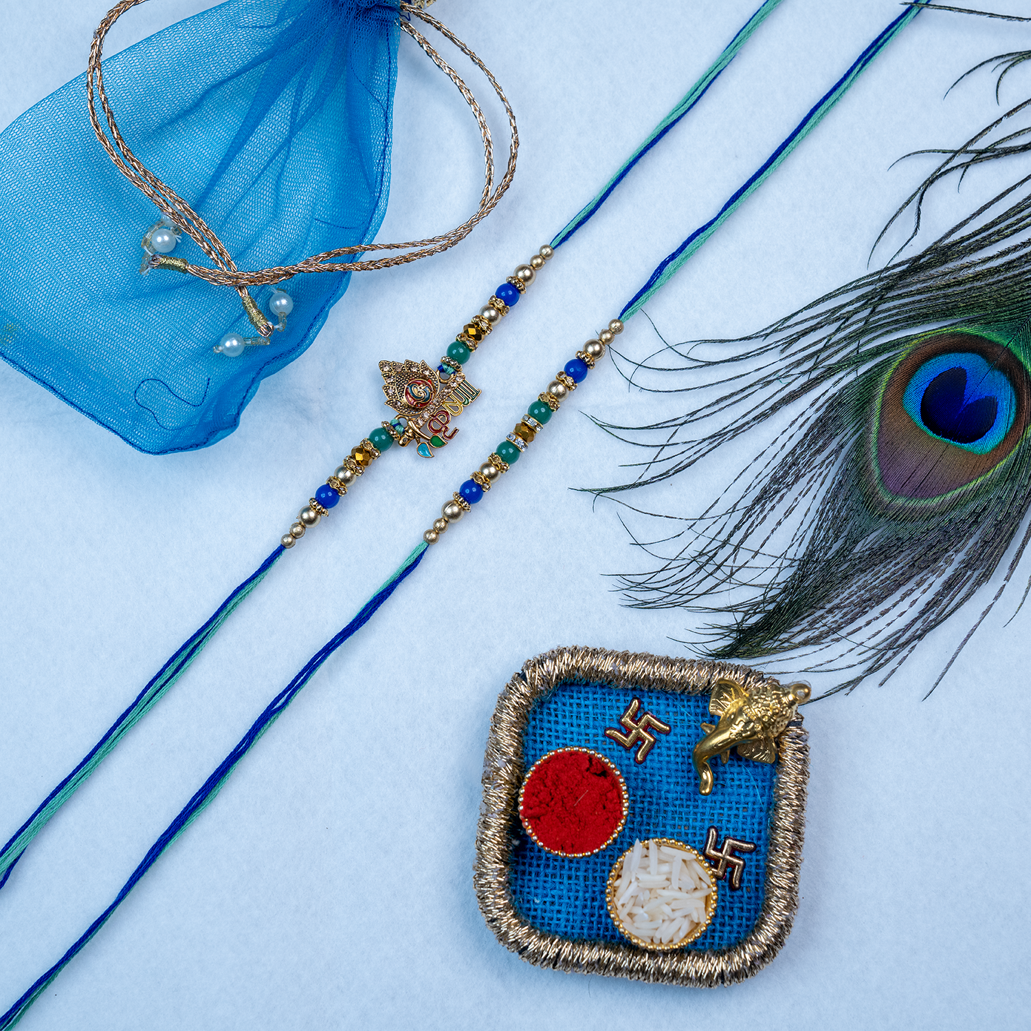 Set of 2 Designer Krishna & Beaded Rakhi with Premium Blue Thali & Potli