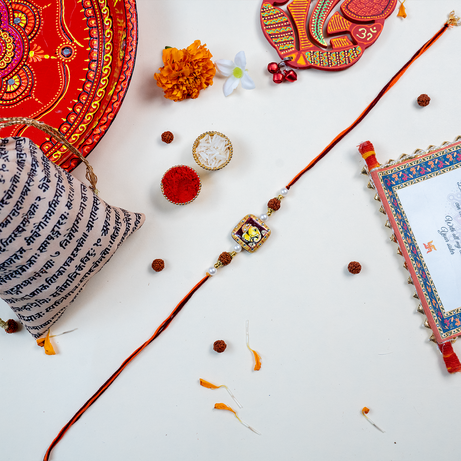 Traditional Divine Ganesha & Pearl Bhaiya Bhabhi Rakhi Combo with Hand-Painted Potli & Scroll Card