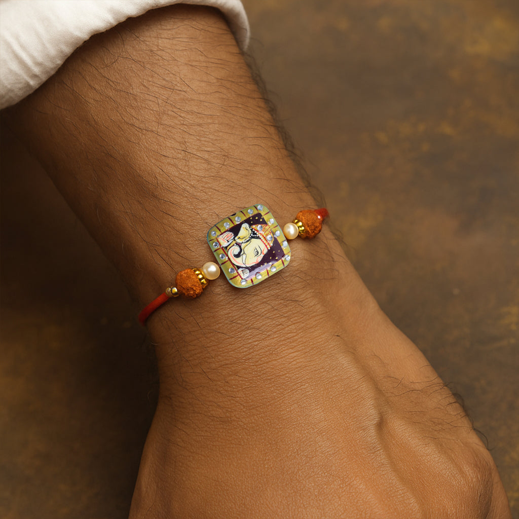 Traditional Divine Ganesha & Pearl Bhaiya Bhabhi Rakhi Combo with Hand-Painted Potli & Scroll Card