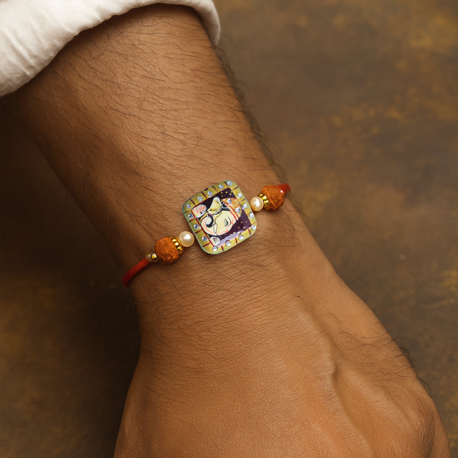 Traditional Divine Ganesha & Pearl Bhaiya Bhabhi Rakhi Combo with Hand-Painted Potli & Scroll Card
